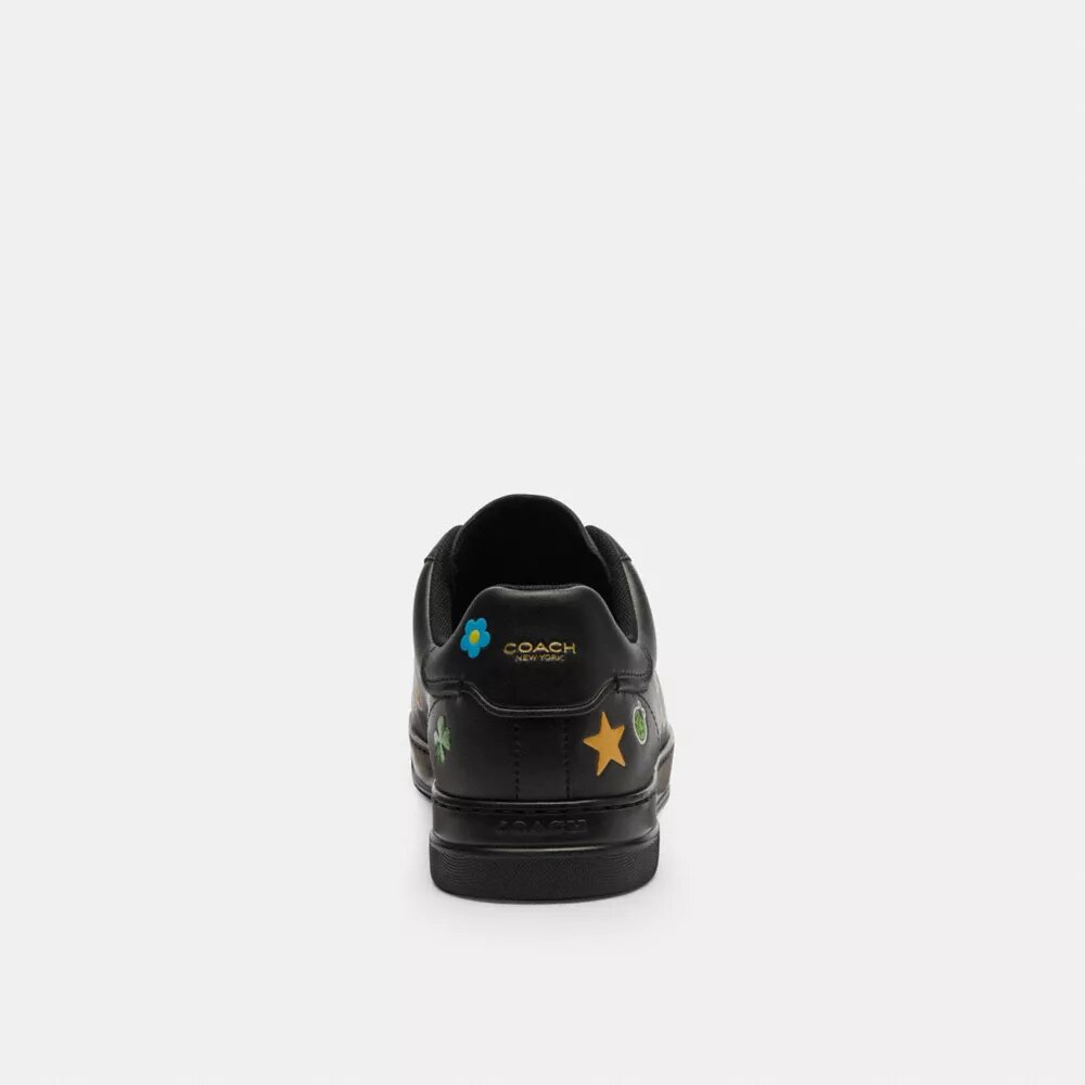 Baskets montantes Disney x Coach avec imprimé autocollant