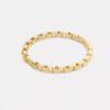 Bracelet rigide à charnière avec chaîne emblématique