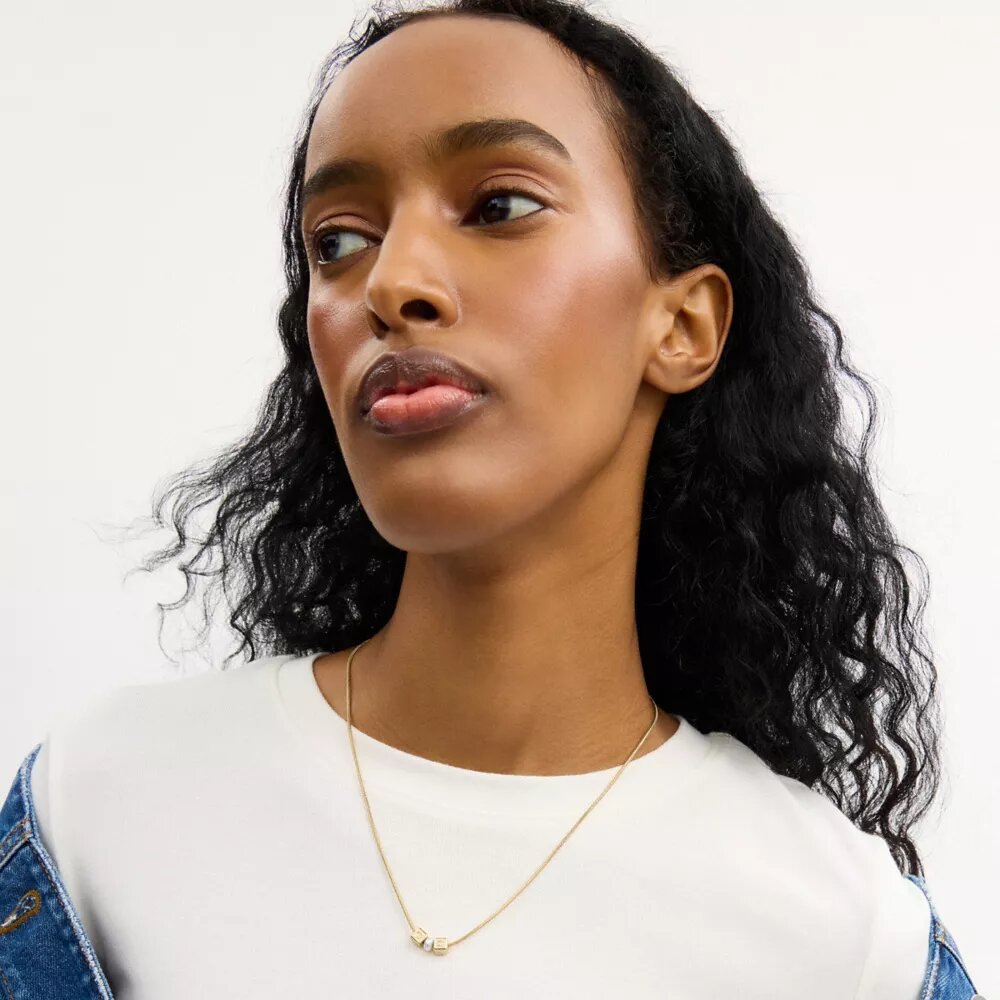 Collier avec pendentif rondelle en perle cubique