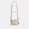 Mini sac bandoulière Carey en Signature Canvas