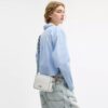Mini sac bandoulière Carey en Signature Canvas