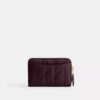 Petit porte-cartes indispensable à fermeture éclair avec matelassage en forme de coussin