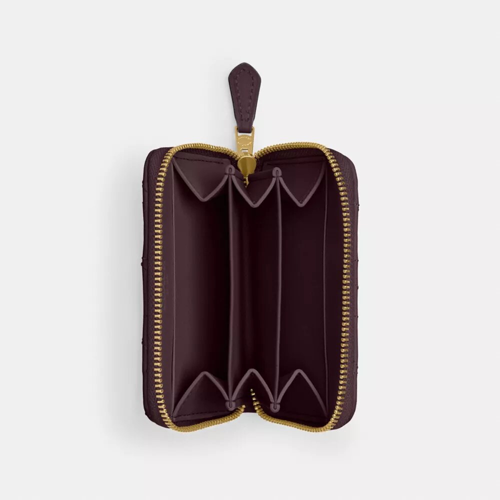 Petit porte-cartes indispensable à fermeture éclair avec matelassage en forme de coussin