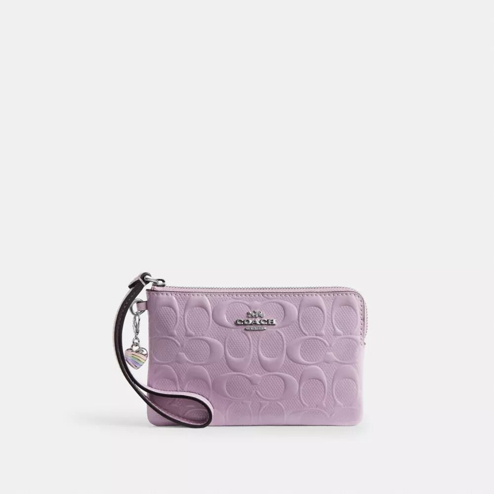 Pochette dragonne à fermeture éclair d'angle en cuir emblématique avec breloque en forme de cœur