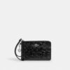 Pochette dragonne à fermeture éclair d'angle en cuir emblématique avec breloque en forme de cœur