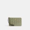 Pochettes dragonne avec fermeture à glissière dans le coin et matelassage
