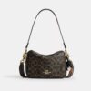 Sac bandoulière Carey en Signature Canvas avec Charms