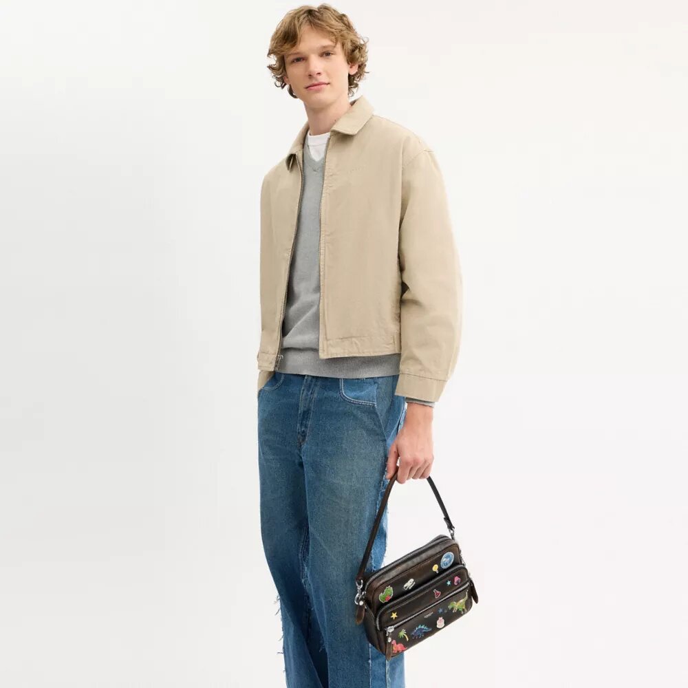 Sac bandoulière Dakota « 10e anniversaire de Rexy » en cuir patiné avec imprimé autocollants