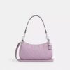 Sac porté épaule Teri en cuir signature avec breloque en forme de cœur